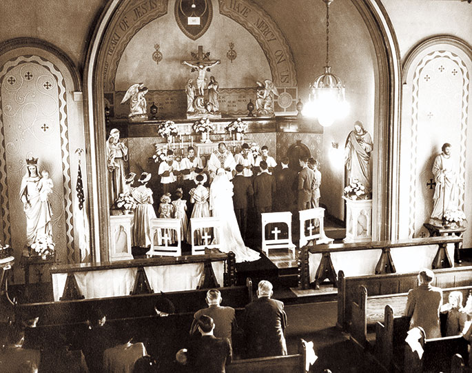 A wedding Mass is celebrated in 1950 at Most Precious Blood Church in New Middleton. Most Precious Blood Parish was founded in 1880. Its original church building burned down in 1927. A new church was constructed the following year and is still in use today. Most Precious Blood Parish is now part of the Tri‑Parish Catholic Community in Harrison County, which also includes St. Joseph Parish in Corydon and St. Peter Parish in Harrison County.