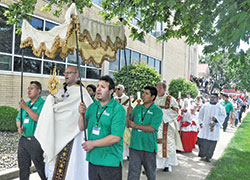 Father Michael Keucher, pastor of St. Joseph Parish in Shelbyville, carries a monstrance holding the Blessed Sacrament at the head of a eucharistic procession on June 23 at the Batesville Deanery faith community. The procession ended with the blessing of the Divine Mercy Chapel, the newest perpetual adoration chapel in the Archdiocese of Indianapolis. (Photo by Sean Gallagher)