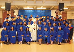 Graduates of the archdiocesan Hispanic Pastoral Leadership Institute are pictured with Archbishop Charles C. Thompson and several priests after a graduation liturgy at St. Andrew the Apostle Church in Indianapolis on June 15. All told, 34 graduates—27 in pastoral leadership, and seven in spiritual direction—received certificates on that day. (Photo by Mike Krokos)