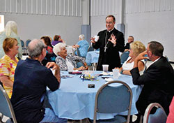 Archbishop Charles C. Thompson shares a lighthearted moment with parishioners of St. Mary Parish in Mitchell during the celebration of the parish’s 150th anniversary on Aug. 11. (Submitted photo by Amy Marshek)