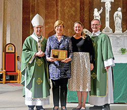 Barbara Hinkle, a member of St. Gabriel Parish in Connersville, holds the Archbishop Edward T. O’Meara Respect Life Award she received at SS. Peter and Paul Cathedral in Indianapolis on Oct. 6. Posing with her are Archbishop Charles C. Thompson, archdiocesan Office of Human Life and Dignity coordinator Brie Anne Varick, and Deacon Michael Braun, director of the archdiocesan Secretariat for Pastoral Ministries. (Photo by Natalie Hoefer)