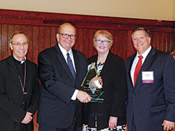 Archbishop Charles C. Thompson is pictured with the St. Thomas More Society’s “Couple for All Seasons Award” honorees on Oct. 1 in the Archbishop Edward T. O’Meara Catholic Center in Indianapolis. Pictured are Archbishop Thompson, left; honorees Judge Brent Dickson and Jan Aikman Dickson; and Patrick Olmstead Jr., president of the St. Thomas More Society of Central Indiana. (Photo by Mike Krokos)
