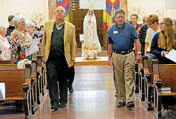 Archdiocesan director of catechesis Ken Ogorek, left, and archdiocesan coordinator of catechetical resources James Wood process with a statue of Our Lady of Fatima during the archdiocese’s Morning with Mary event in Church of the Immaculate Conception at Saint Mary-of-the-Woods, in St. Mary-of-the-Woods, on Oct. 5. (Photo by Natalie Hoefer)