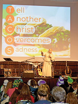 At a Deep Dive session on Nov. 22, Franciscan Friars of the Renewal Father Agustino Torres uses a TACOS acronym to remind NCYC youths to “tell another Christ overcomes sadness.” (Photo by Natalie Hoefer)