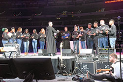 Benedictine Brother John Mark Falkenhain, a monk of Saint Meinrad Archabbey in St. Meinrad, leads youths in chanting the “Salve Regina” (“Hail Holy Queen”) on Nov. 22 in Lucas Oil Stadium in Indianapolis during the National Catholic Youth Conference. (Photo by Sean Gallagher)