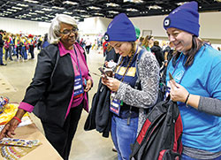 Franciscan Sister Janette Pruit, a member of the Sisters of St. Francis of Oldenburg, speaks on Nov. 22 in the Indiana Convention Center in Indianapolis during the National Catholic Youth Conference to Celina Feldhake, left, and Amanda Merkes, both of Archdiocese of Dubuque, Iowa. (Photo by Sean Gallagher)