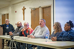 Russell Boyd, center, speaks about his imprisonment for more than 43 years, 10 of which were spent on Indiana’s death row, during the Corrections Ministry Conference at St. Paul Catholic Center in Bloomington on Nov. 16. Boyd was part of a panel of formerly incarcerated persons led by Deacon Marc Kellams, far left. The conference was the third of its type and marks an increased effort by the archdiocese to better organize and equip people who minister in jails and prisons. Panel members included Richard Samuels, left, David Steele, Russell Boyd, Maria Luttrell and Jay David. (Photos by Katie Rutter)