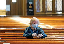 Alice Claus prays the rosary at St. Kevin Church in the Flushing section of the New York City borough of Queens on May 26, the first day the Diocese of Brooklyn, N.Y., permitted its churches to reopen amid the COVID-19 pandemic. Catholic mental health clinicians in Indianapolis spoke recently with The Criterion about the psychological and emotional challenges the pandemic has caused for many people.  (CNS photo/Gregory A. Shemitz)