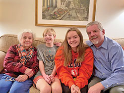 The prayers of family and friends were instrumental in helping Grace Krokos, mother of Criterion editor Mike Krokos, overcome a life-threatening health crisis in Ecuador earlier this year. Pictured, Grace, left; grandchildren Stephen and Elizabeth; and her son Mike. (Submitted photo by Madeline Krokos)