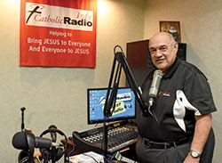 Jim Ganley, the retiring general manager and president of Catholic Radio Indy, stands on Sept. 21 in the station’s studio in Indianapolis that has now been named after him. He has helped lead the station since it went on the air in 2004. (Photo by Sean Gallagher)