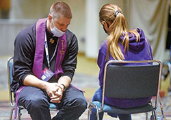 Father Andy Hammeke of the Diocese of Salina, Kan., hears the confession of a National Catholic Youth Conference participant on Nov. 20 in a ballroom of the Indiana Convention Center in Indianapolis. (Photo by Sean Gallagher)