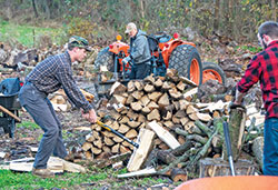 Seminarian Isaac Siefker, at left, a member of St. John the Apostle Parish in Bloomington, chops wood on Nov. 12 on the grounds of Saint Meinrad Seminary and School of Theology in St. Meinrad. He volunteers with Project Warm, an initiative in which seminarians and other volunteers collect, chop and deliver firewood for people in need in four counties around Saint Meinrad. (Photo courtesy of Saint Meinrad Archabbey)