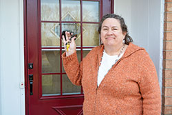 Linda Kile, president and director of Gabriel Project, smiles with joy as she holds the keys to the southwest side Indianapolis home recently purchased as the new site of the organization’s 1st Choice for Women pregnancy care center, which has been without headquarters since their offices were burned in a building fire in 2019. Pending rezoning the property for commercial use, she hopes the pregnancy care center will open in the summer. (Photo by Natalie Hoefer)
