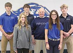 Every year for 70 years, at least one descendant of Ambrose and Mary Rose Kruer has attended Our Lady of Providence High School in Clarksville. Here, five of their great-grandchildren pose for a photo with one of their children, Norman Kruer. Sophomore Nina Kruer, left, and senior Peyton Kruer are in the front row. Senior Eli Krussow, left, senior Grant Williams and sophomore Luke Kruer are in the back row. (Submitted photo)