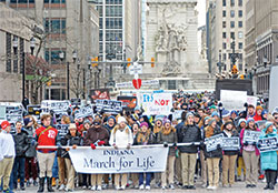 The front half of an estimated 1,000 participants in the Indiana March for Life in Indianapolis on Jan. 24 head toward the Indiana Statehouse for a pro-life rally. The other half wrap around the south side of the Soldiers and Sailors Monument seen in the background. (Photo by Natalie Hoefer)