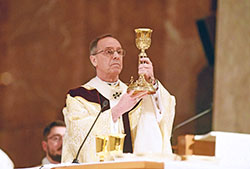 Archbishop Charles C. Thompson elevates a chalice during the archdiocesan chrism Mass on April 12 at SS. Peter and Paul Cathedral in Indianapolis. The chalice belonged to the Servant of God Bishop Simon Bruté, the founding bishop of the Diocese of Vincennes, Ind., which later became the Archdiocese of Indianapolis. (File photo by Sean Gallagher)