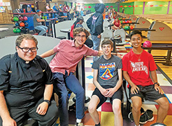 Then-transitional Deacon Matthew Perronie has fun on July 25, 2021, with Grant Dierking, second from left, Evan Campbell and Nathan Hyun during an outing at Blackiston Bowl in Clarksville for the youth group of Our Lady of Perpetual Help Parish in New Albany. (Submitted photo)
