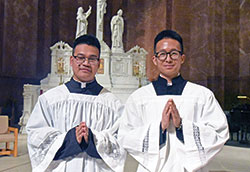 Archdiocesan seminarians Timothy Khuishing, left, and Khaing Thu pose on April 12 in SS. Peter and Paul Cathedral in Indianapolis. (Photo by Sean Gallagher)