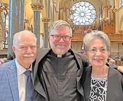 Newly ordained Richmond native Jesuit Father Joseph Kraemer smiles with his parents Mike and Melanie Kraemer in Church of the Gesu in Milwaukee on June 11. His parents raised him in the former St. Andrew Parish in Richmond, now part of St. Elizabeth Ann Seton Parish, where Mike and Melanie worship. (Submitted photo)