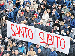 People hold up a sign saying, “santo subito” (“sainthood now”) at the end of the funeral Mass for Pope Benedict XVI in St. Peter’s Square at the Vatican on Jan. 5. (CNS photo/Chris Warde-Jones)
