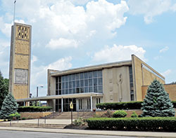 With its clean lines, barely bowed front, large windows and minimal ornamentation, St. Rita Church in Indianapolis, built in 1958-59, is a prime example of Mid-Century Modern architecture. For this reason and for the parish’s spiritual, social and historical impact, the parish has received several preservation grants, including a matching grant to restore its bell tower, seen at left in this photo. (Submitted photo by Caleb Legg)