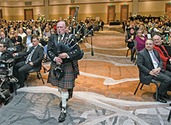Bagpiper Les Miller plays a mournful rendition of “Amazing Grace” during an emotional tribute to the late Deacon Marc Kellams and his late daughter, Katie Kellams Reed, at the archdiocese’s Legacy Gala at the JW Marriott in Indianapolis on Feb. 10. (Photo by Rob Banayote)