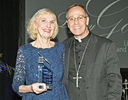 Archbishop Charles C. Thompson poses for a photo with Mary Jo Thomas-Day after she received the archdiocese’s Legacy Award at the Legacy Gala at the JW Marriott in Indianapolis on Feb. 10. (Photo by Rob Banayote)