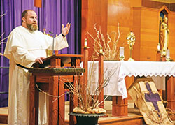 Dominican Father Patrick Hyde, pastor of St. Paul Catholic Center in Bloomington, speaks about the Eucharist on March 16 during an eucharistic evening of reflection at Holy Family Church in New Albany. (Photo by Sean Gallagher)