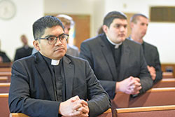 Then-seminarian José Neri, left, kneels in prayer on Aug. 9, 2021, in the chapel of Our Lady of Fatima Retreat House in Indianapolis. Neri. who was ordained a transitional deacon in 2022, will be ordained a priest for the archdiocese on June 3 at SS. Peter and Paul Cathedral in Indianapolis. (Criterion file photo by Sean Gallagher)