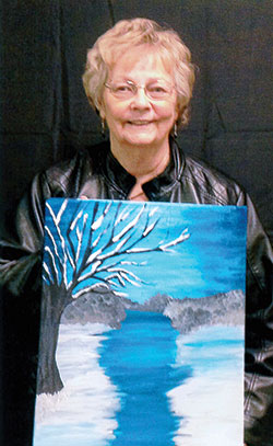At right, Joan Greiwe holds a painting she created during an outing with six of her sisters. (Submitted photo)