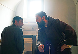 Father Pio hears the confession of a penitent in the film Padre Pio. (Photo courtesy of Gravitas Ventures)