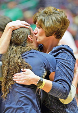 One of the great joys of Terri Purichia’s 25 year of coaching at Our Lady of Providence High School in Clarksville has been sharing seasons and special moments with her three daughters, Maggie, Anna and Grace. Here, she shares a hug with Grace after the team won Indiana’s 3A state championship in 2022. (Submitted photo)
