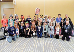 Teenagers and chaperones from St. Gabriel Parish in Connersville and St. Bridget of Ireland Parish in Liberty pose in the Indiana Convention Center in Indianapolis on Nov. 17 with their pastor, Father Dustin Boehm. (Photo by Mike Krokos)