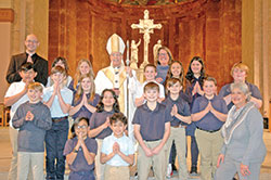 Archbishop Charles C. Thompson poses for a photo with a group from St. Joseph School in Shelbyville after the archdiocese’s Catholic Schools Week Mass in SS. Peter and Paul Cathedral on Jan. 31. (Photo by John Shaughnessy)