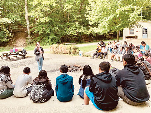 Nelly Bonilla, a Catholic psychologist from Minnesota, leads a talk for youths titled “How social media could affect your mental health.” The workshop was part of a family camp experience at CYO Camp Rancho Framasa in Brown County last fall. (Submitted photo by Felix Navarrete)