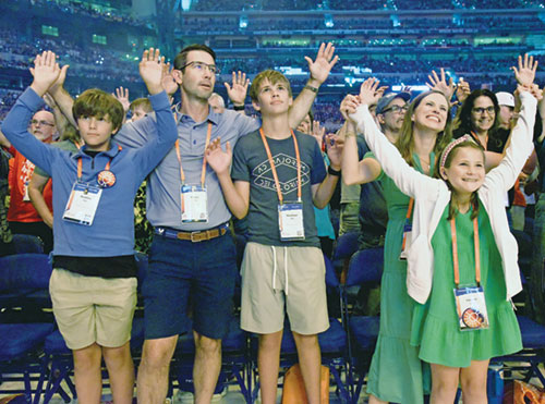 Maddox, left, Fraser, Markham, Lindsay and Hannah Hay of Colleyville, Texas, enjoy a performance by Catholic recording artist Matt Maher on July 20 in Lucas Oil Stadium in Indianapolis during the National Eucharistic Congress. (Photo by Sean Gallagher)
