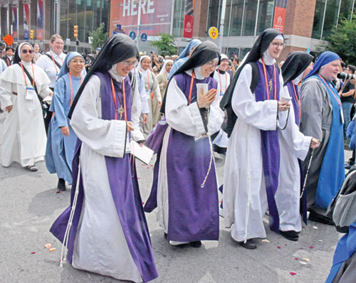 Women religious, wearing a variety of habits, take part in a eucharistic procession on July 20 in downtown Indianapolis during the National Eucharistic Congress. (Photo by Sean Gallagher)