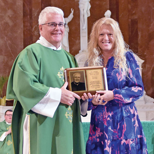 Annissa Kellum of St. Michael Parish in Bradford receives the archdiocese’s Archbishop O’Meara Respect Life Award from Deacon Thomas Hosty during the archdiocesan Respect Life Mass at SS. Peter and Paul Cathedral in Indianapolis on Oct. 5. October is Respect Life Month in the Church in the United States. (Photo by Natalie Hoefer)