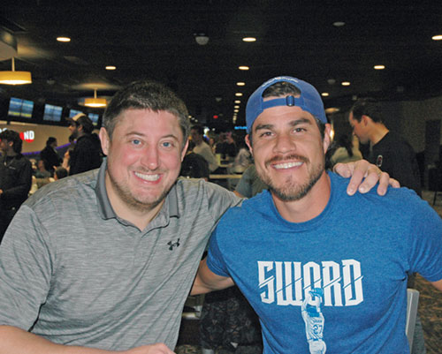 More than great friends and bowling teammates, Andrew Moster, left, served as the sponsor for Thomas Robbins as he was received into the full communion of the Church earlier this year. (Photo by John Shaughnessy) 