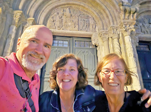 Mike and Rebecca Kirsch, center, pose with their new friend Kathy outside of the Cathedral of Santiago de Compostela in Spain after they complete their Camino journey in 2025. (Submitted photo)