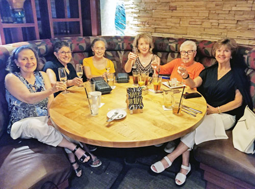 Members of the St. Augustine Home Guild planning group pause to celebrate a birthday during a monthly gathering as they prepare for the annual Hats Off to Spring fundraiser, benefiting the Little Sisters of the Poor at St. Augustine Home in Indianapolis. Pictured are: Angie Bagnoli, left, Joanne Dyer, Patricia Damler, Linda Rambicure, Sherry Porter, and Debbie Kukla. (Photo courtesy of St. Augustine Home Guild)
