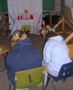 Youth praying in makeshift chapel
