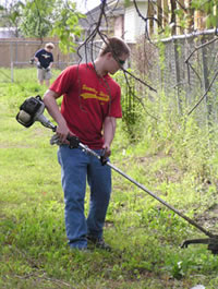 Youth helping tend to a lawn
